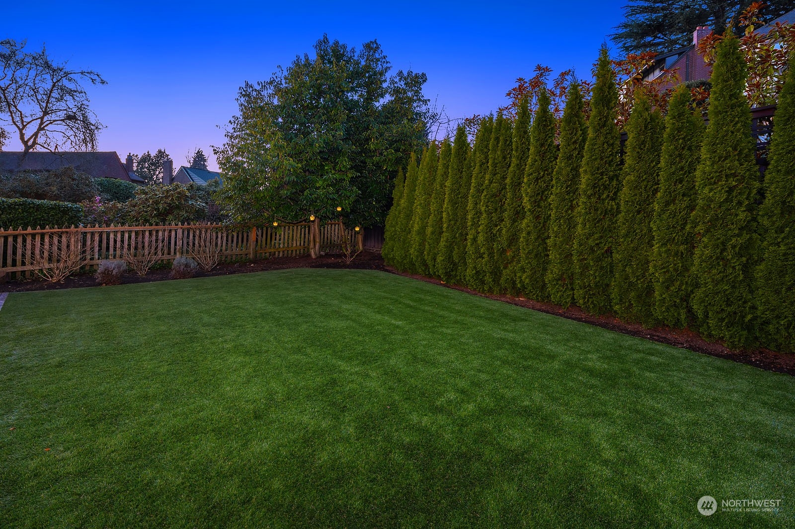 5108 Northeast 42nd Street Seattle, WA 98105 - Photo 35 of 40 a view of a yard with a house in the background