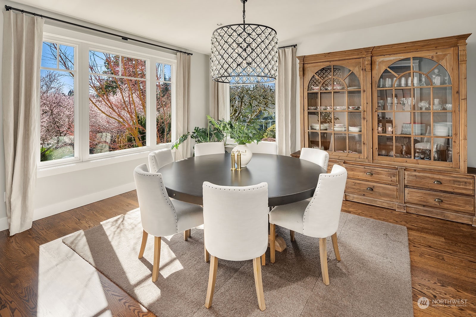 5108 Northeast 42nd Street Seattle, WA 98105 - Photo 5 of 40 a dining room with furniture a chandelier and wooden floor