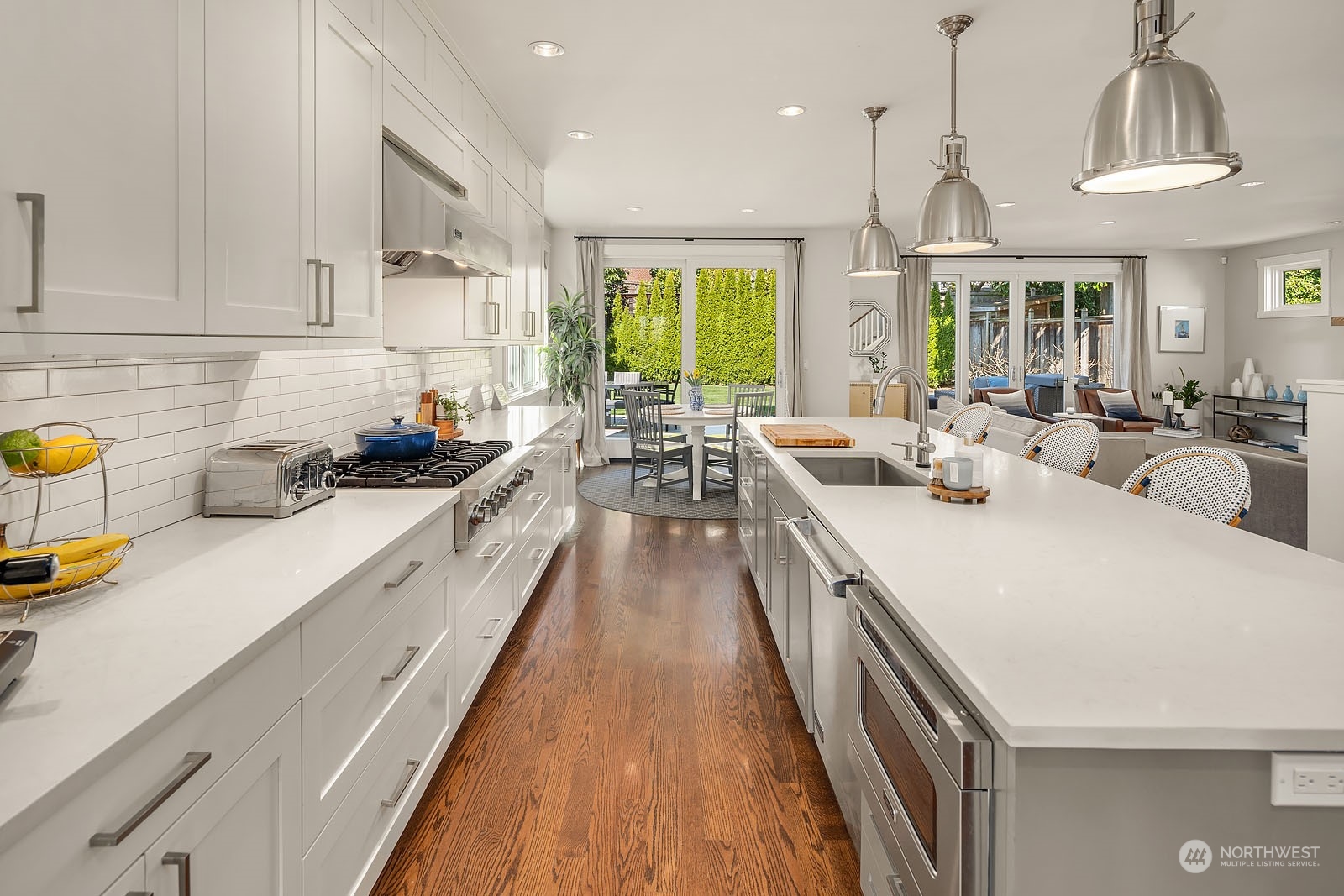 5108 Northeast 42nd Street Seattle, WA 98105 - Photo 8 of 40 a large kitchen with sink a counter space and stainless steel appliances