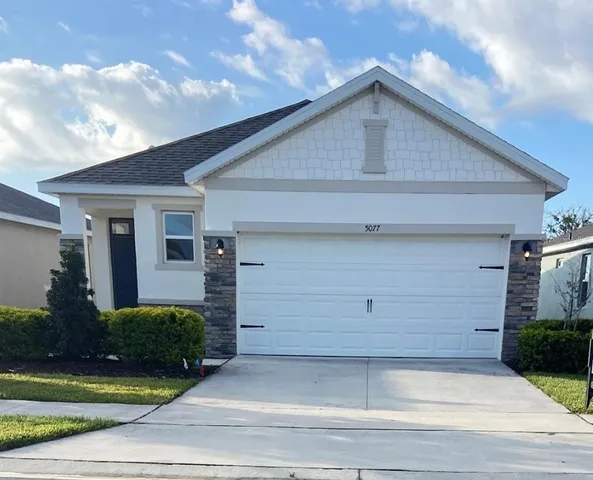 a front view of a house with garage