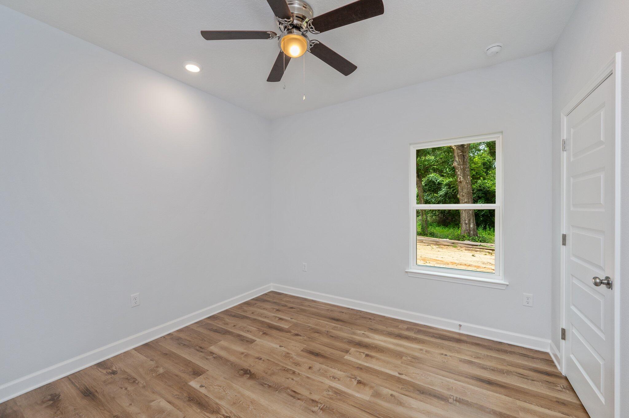 858 South Rayburn Street Crestview, FL 32539 - Photo 11 of 29 an empty room with a window and a fan
