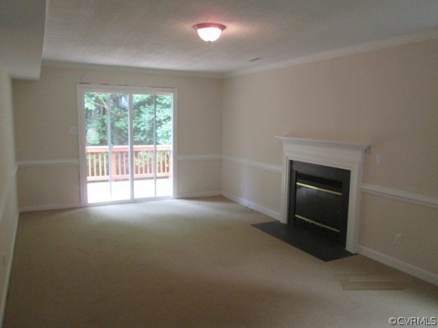 5707 Standing Oak Road Midlothian, VA 23112 - Photo 3 of 10 an empty room with a fireplace and a window