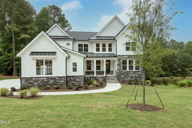 a view of a house with a yard patio and fire pit