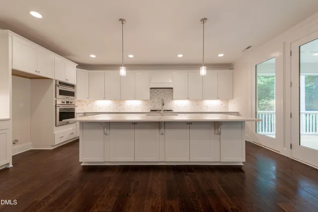 a stove top oven sitting inside of a kitchen