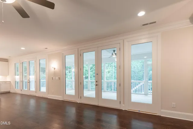 an empty room with windows and closet