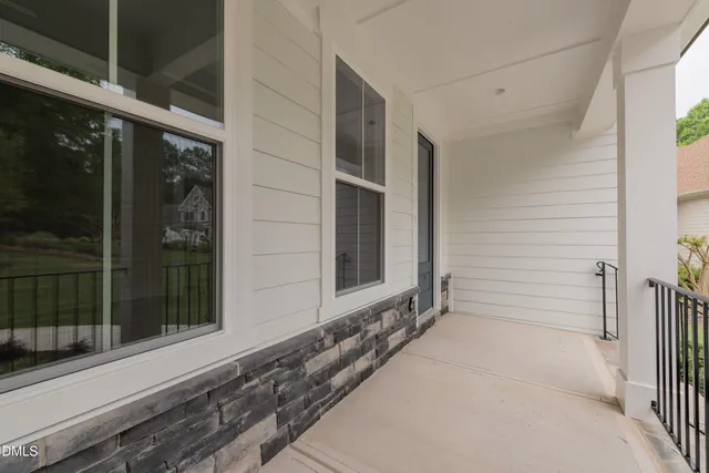 a kitchen with granite countertop white cabinets and sink