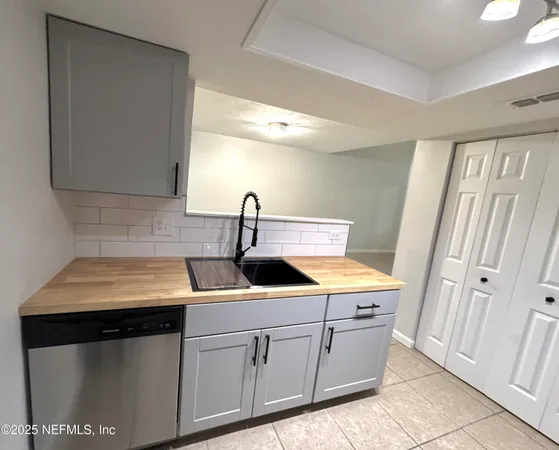 a kitchen with a sink and cabinets
