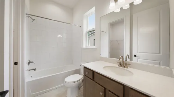 a bathroom with a double vanity sink mirror and a toilet