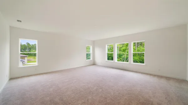 an empty room with windows and outdoor view