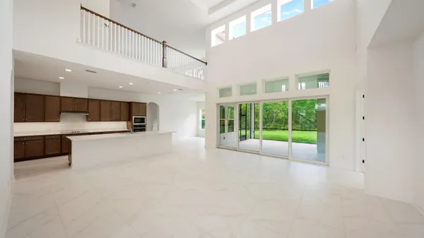 a kitchen with stainless steel appliances a sink a stove a refrigerator cabinets and a counter top space