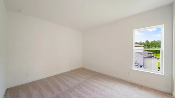 a backyard of a house with lots of green space and plants