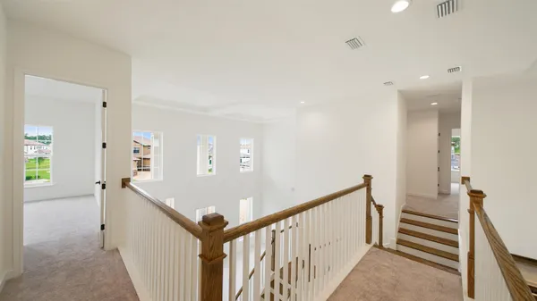an aerial view of a city with lots of residential buildings ocean and mountain view in back