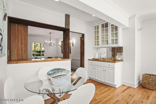 23 Parsonage Road Greenwich, CT 06830 - Photo 13 of 41 a kitchen with granite countertop white cabinets and chairs