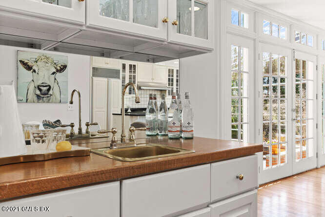 23 Parsonage Road Greenwich, CT 06830 - Photo 14 of 41 a bathroom with a sink and a mirror