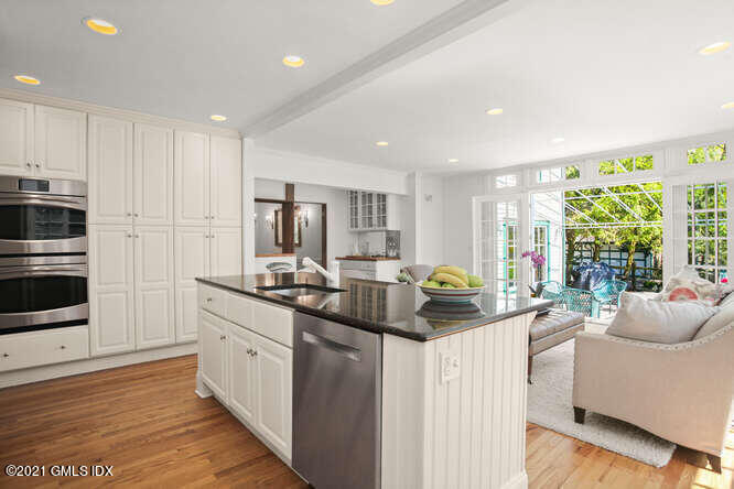 23 Parsonage Road Greenwich, CT 06830 - Photo 15 of 41 a kitchen with stainless steel appliances kitchen island granite countertop a stove a sink a refrigerator and white cabinets with wooden floor