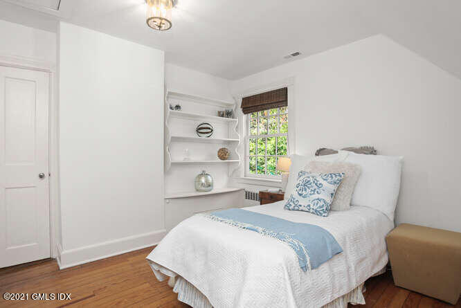 23 Parsonage Road Greenwich, CT 06830 - Photo 26 of 41 a bedroom with a bed and a window