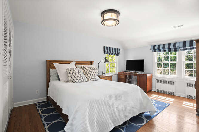 23 Parsonage Road Greenwich, CT 06830 - Photo 28 of 41 a bedroom with a bed and a flat screen tv