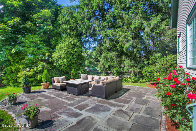23 Parsonage Road Greenwich, CT 06830 - Photo 34 of 41 a backyard of a house with a yard and outdoor seating