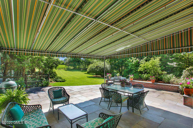 23 Parsonage Road Greenwich, CT 06830 - Photo 36 of 41 a view of a patio with table and chairs and a barbeque