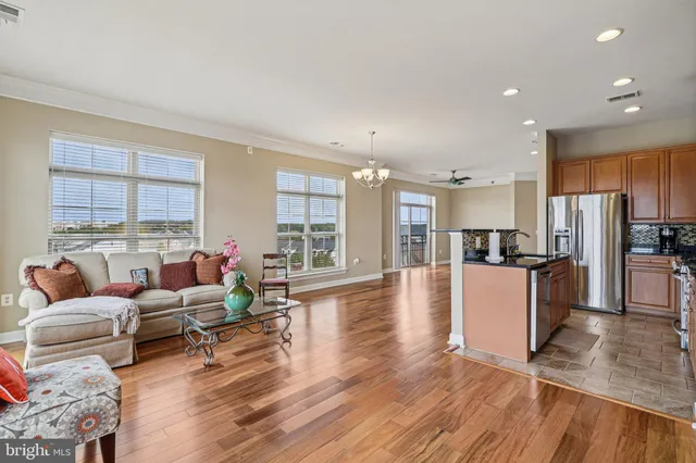 a living room with furniture window and wooden floor