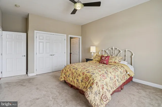 a bedroom with a bed and ceiling fan
