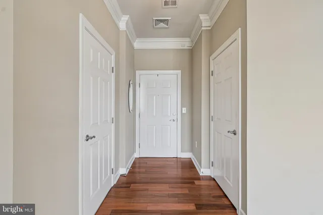 a view of a hallway with wooden floor