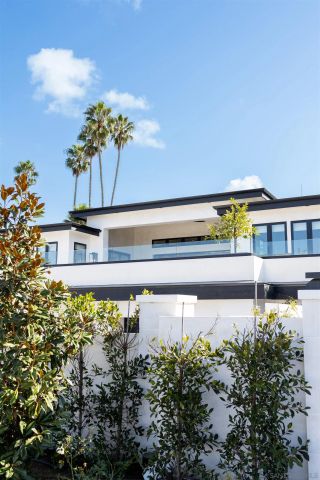a bathroom with a granite countertop double vanity sink a mirror and a bathtub