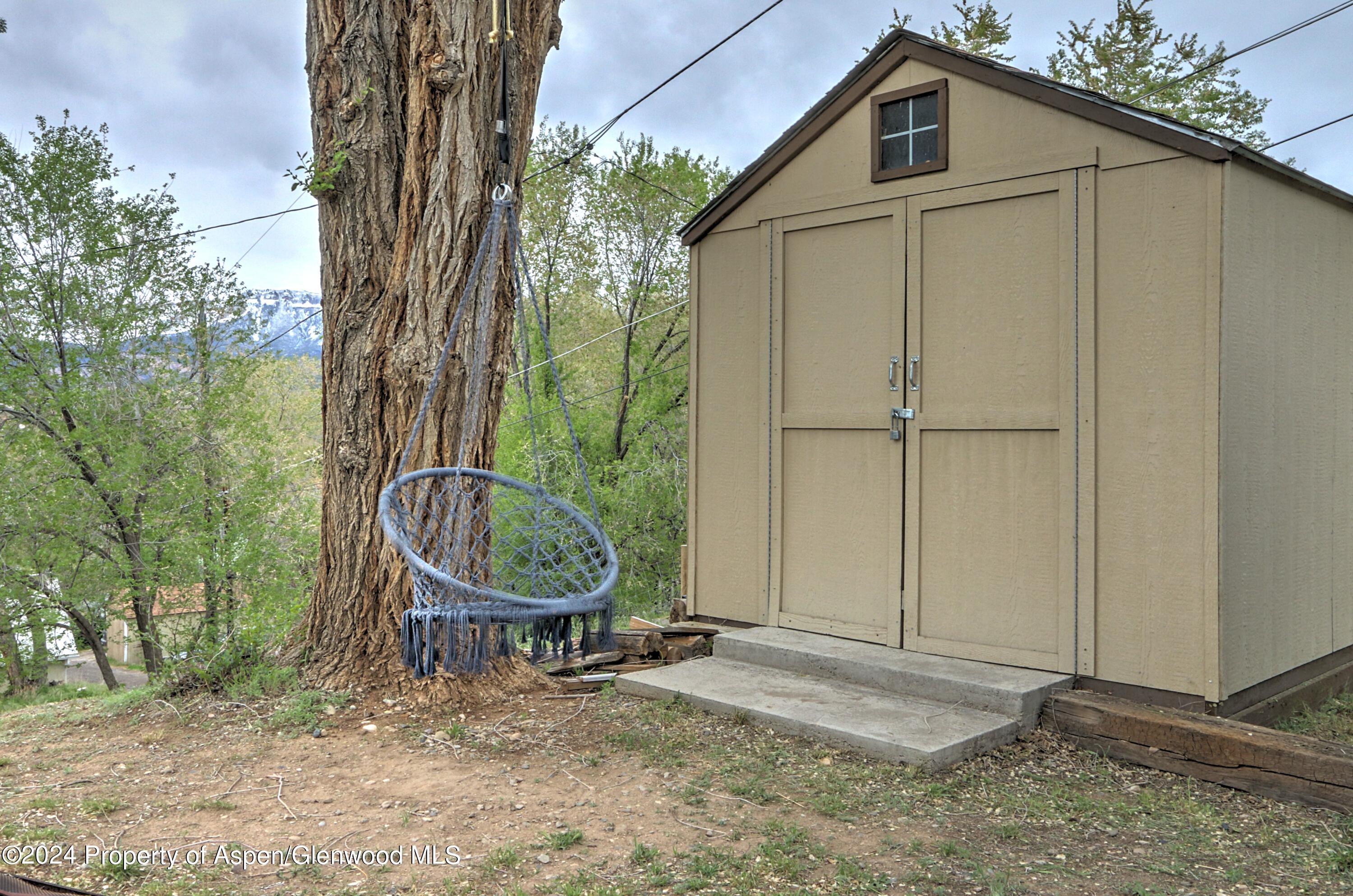 412 East 4th Street Rifle, CO 81650 - Photo 14 of 18 a backyard of a house with table and chairs