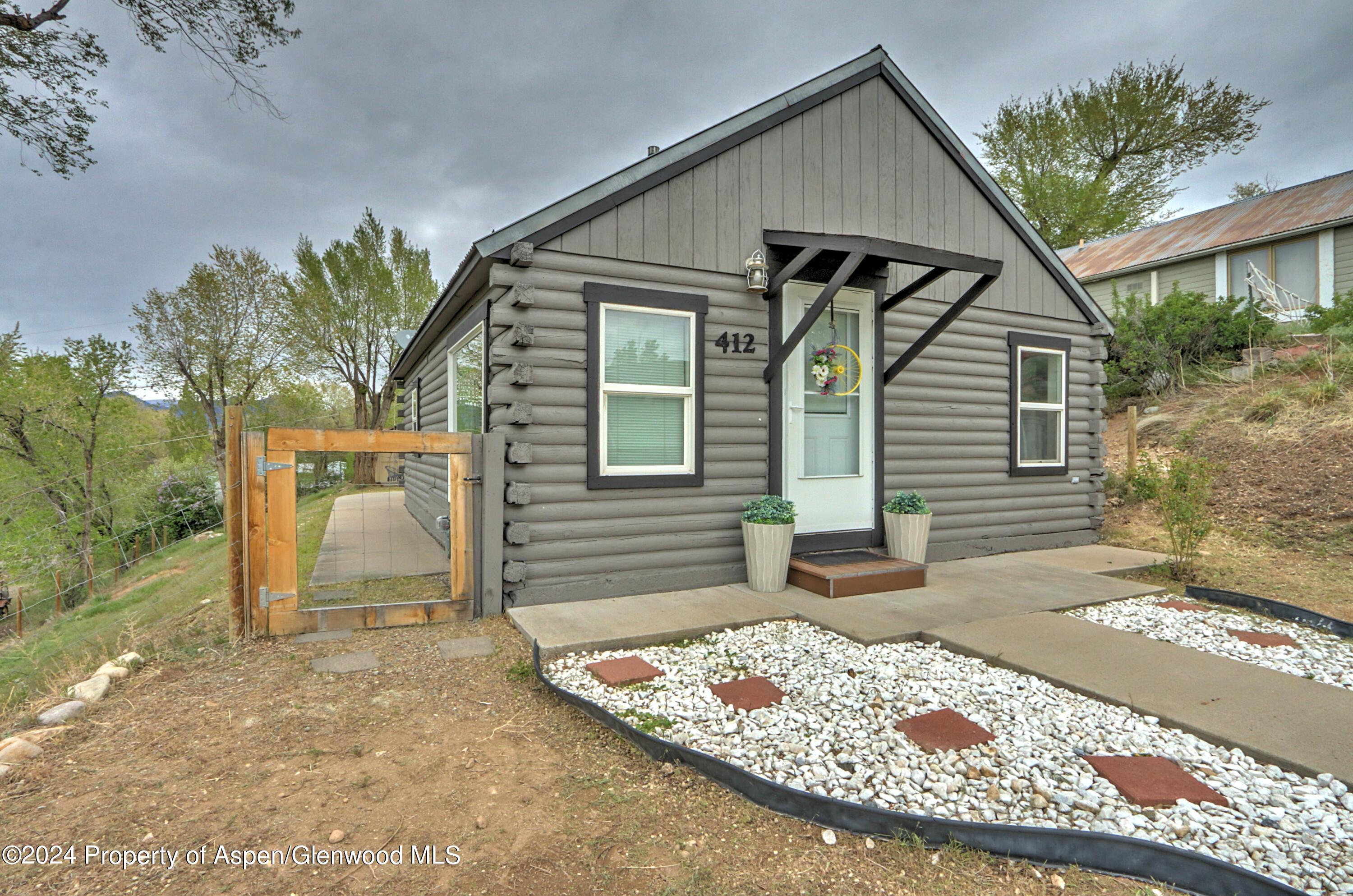 412 East 4th Street Rifle, CO 81650 - Photo 18 of 18 a front view of a house with garden
