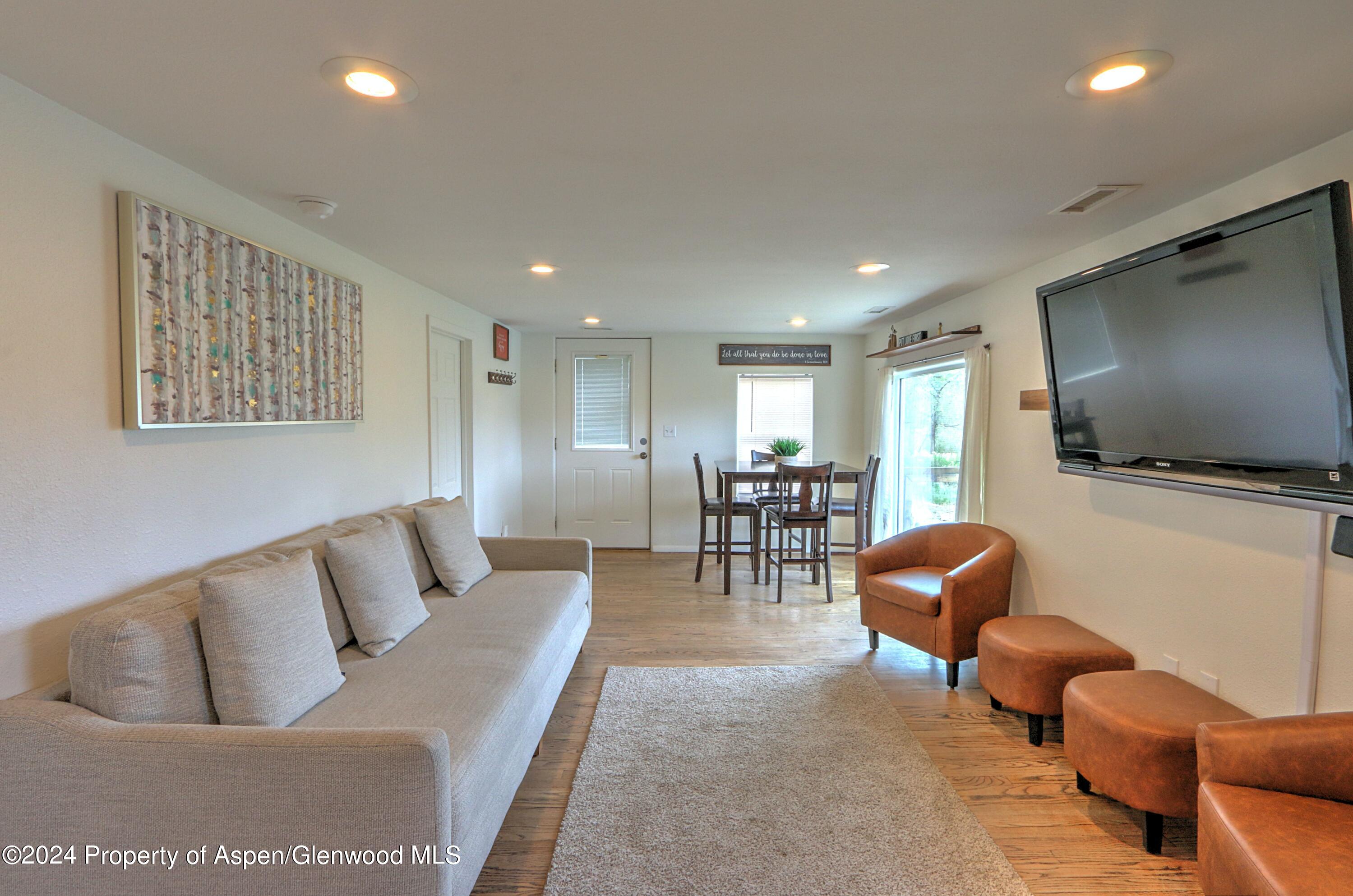 412 East 4th Street Rifle, CO 81650 - Photo 2 of 18 a living room with furniture and a flat screen tv
