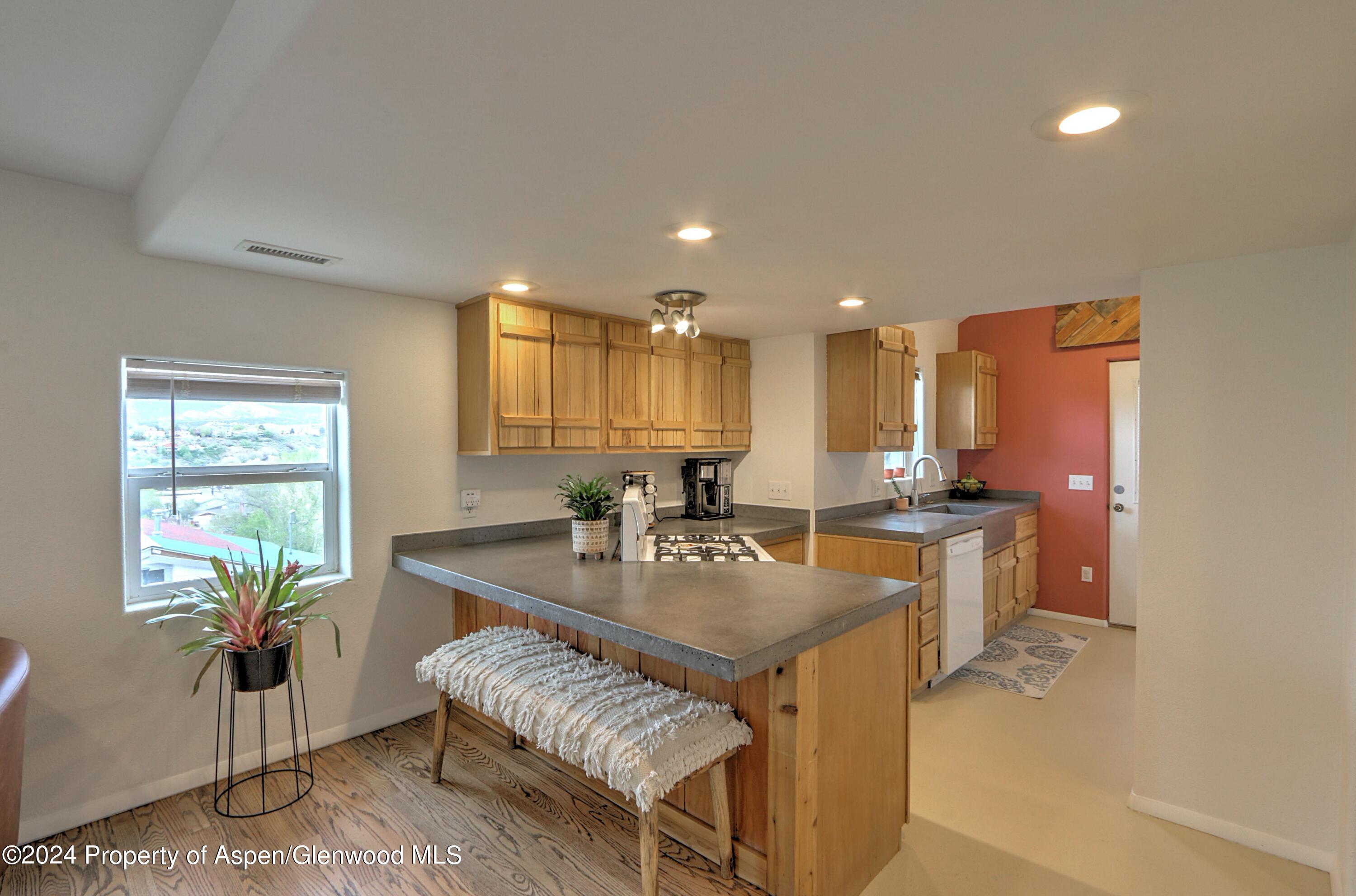 412 East 4th Street Rifle, CO 81650 - Photo 3 of 18 a view of kitchen island a sink wooden floor and living room view