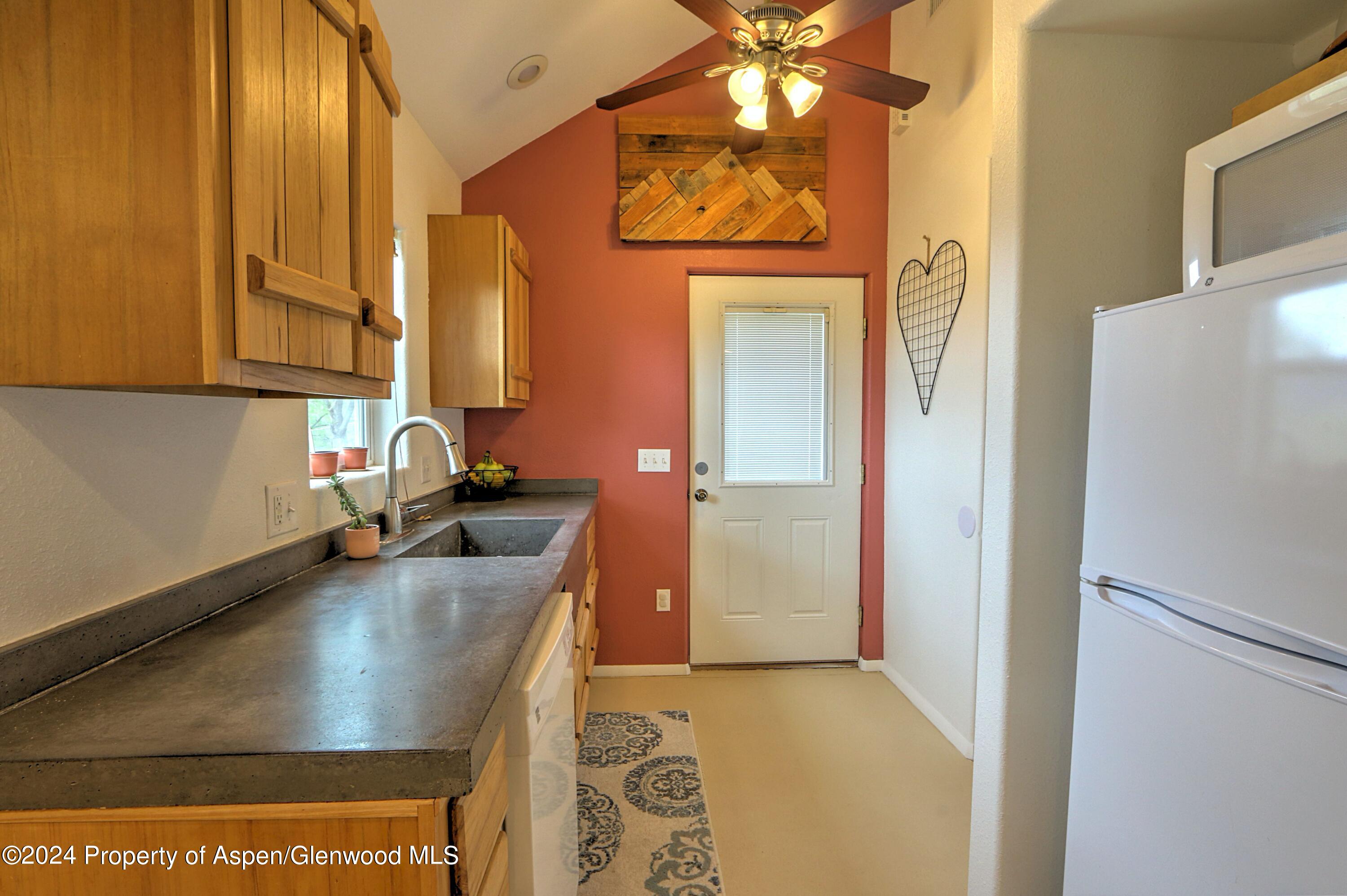 412 East 4th Street Rifle, CO 81650 - Photo 5 of 18 a kitchen with a refrigerator and a sink