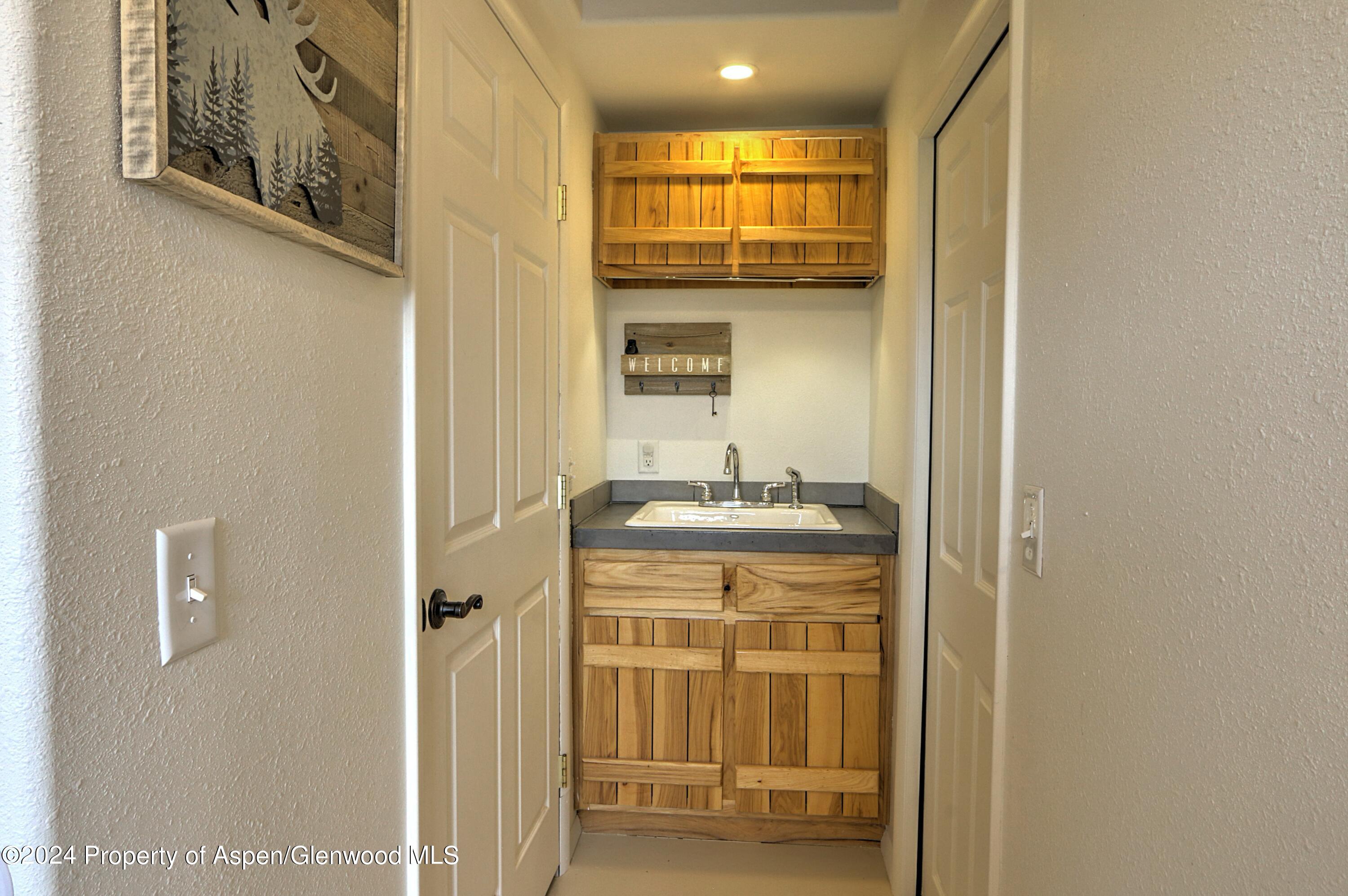 412 East 4th Street Rifle, CO 81650 - Photo 8 of 18 a bathroom with a sink and a mirror