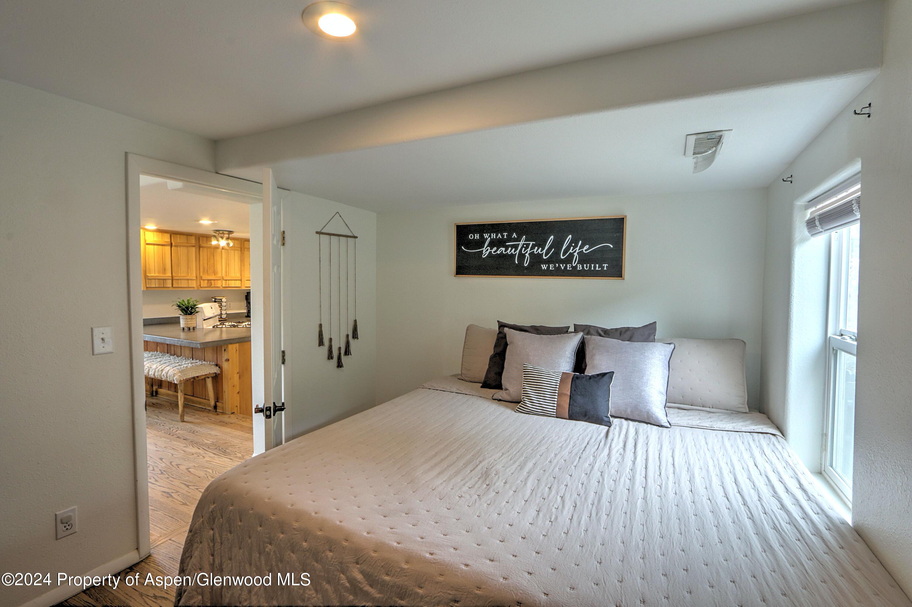 412 East 4th Street Rifle, CO 81650 - Photo 9 of 18 a bedroom with a bed and a view of bathroom