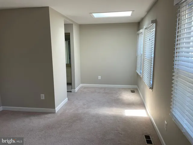 a view of an empty room with windows