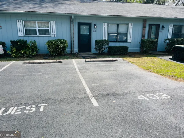 a front view of a building with garden