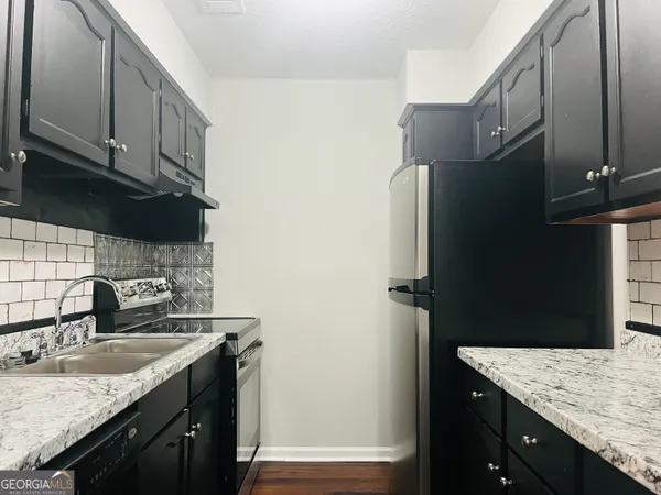 a kitchen with a sink and cabinets