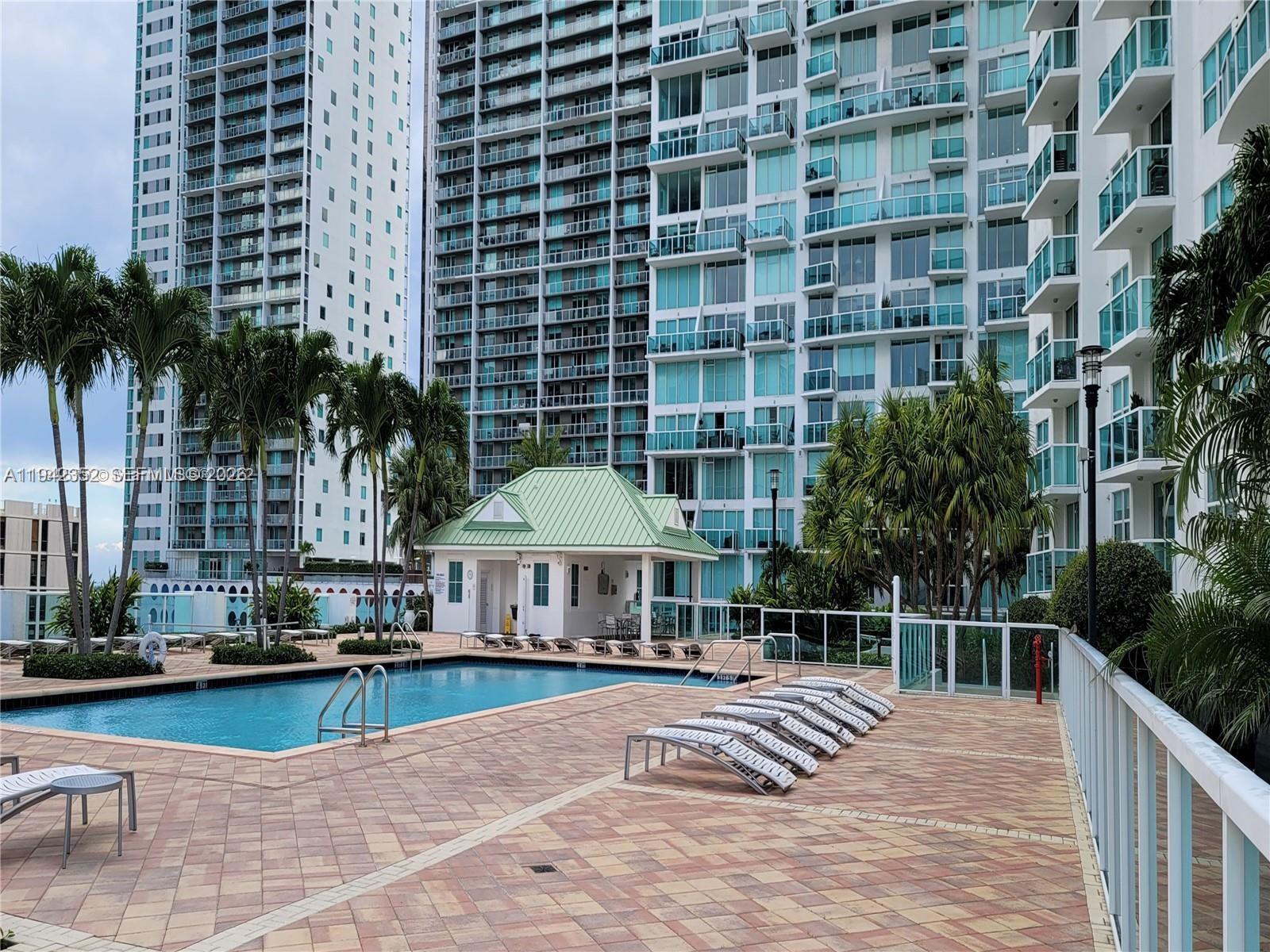 41 Southeast 5th Street, Unit 2112 Miami, FL 33131 - Photo 43 of 45 a swimming pool with outdoor seating and yard