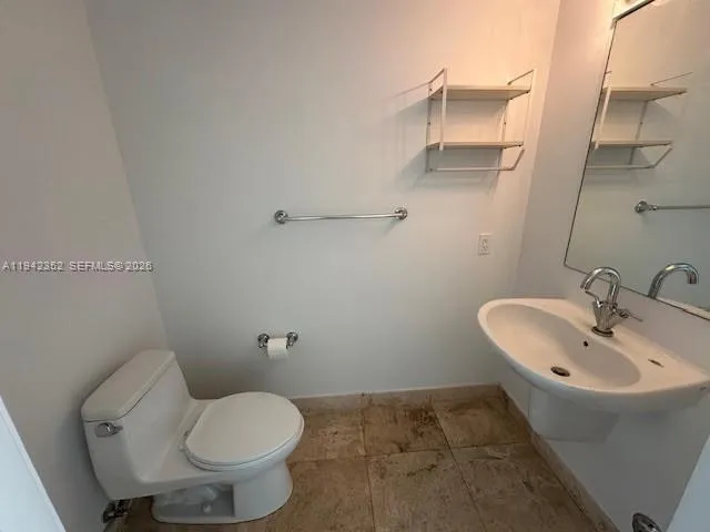 a bathroom with a sink and toilet