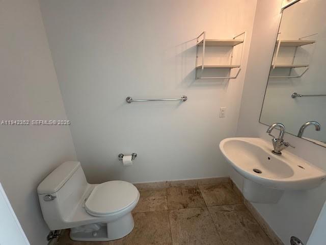 41 Southeast 5th Street, Unit 2112 Miami, FL 33131 - Photo 9 of 45 a bathroom with a sink and toilet