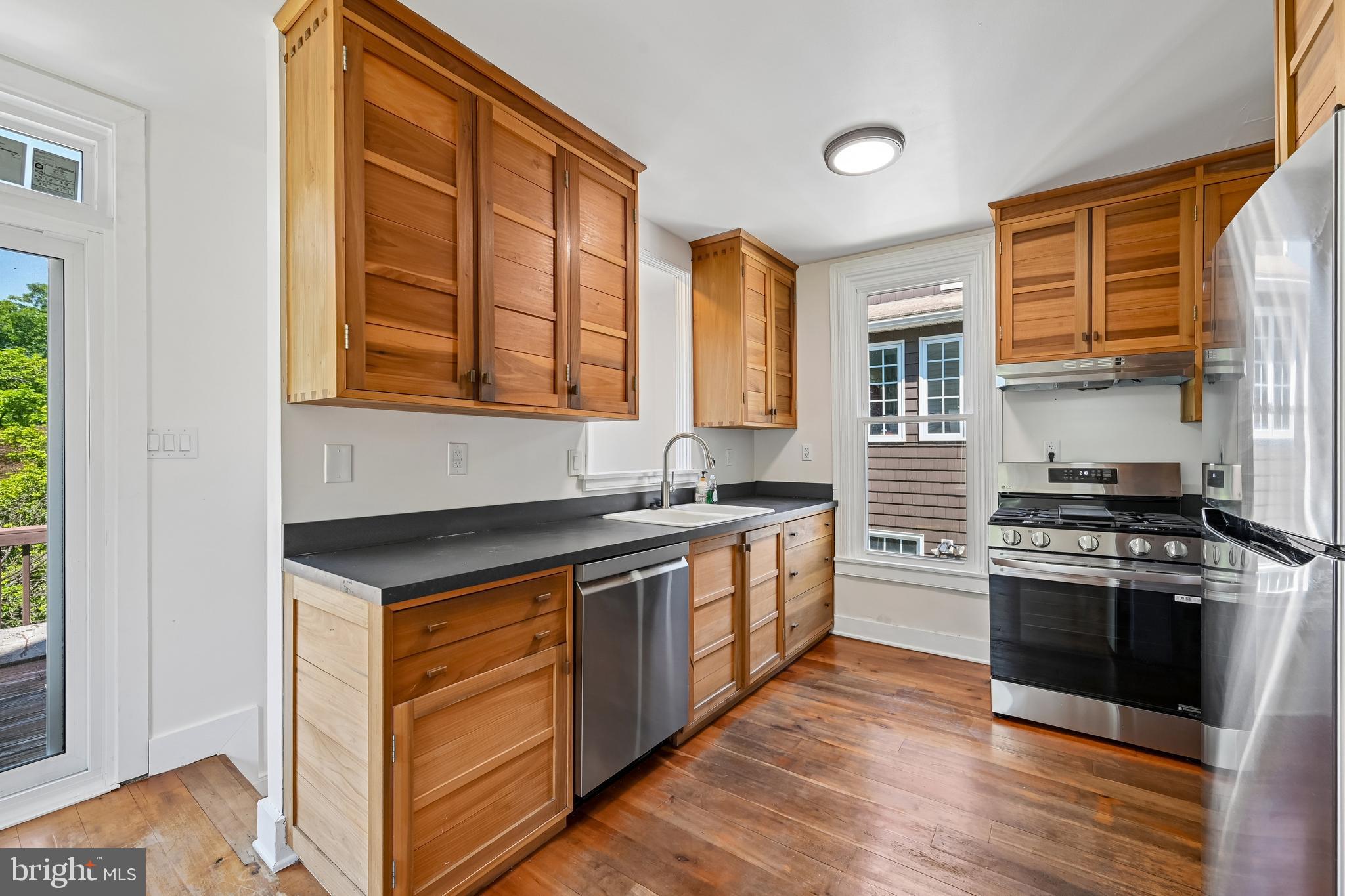 5702 Falls Road Baltimore, MD 21209 - Photo 15 of 49 a kitchen with stainless steel appliances granite countertop a stove and a sink
