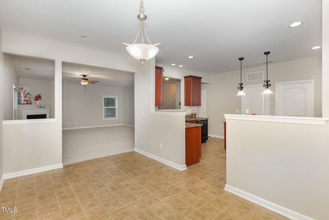 a view of a kitchen and an empty room