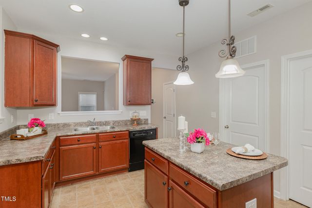 a kitchen with sink stove and microwave