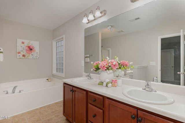 a bathroom with a sink double vanity and a mirror