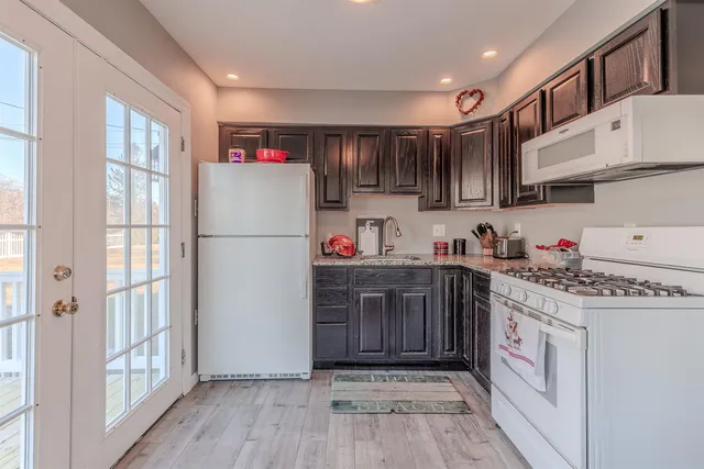 a kitchen with stainless steel appliances granite countertop a refrigerator and a stove top oven