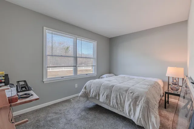 a view of bedroom with furniture and window