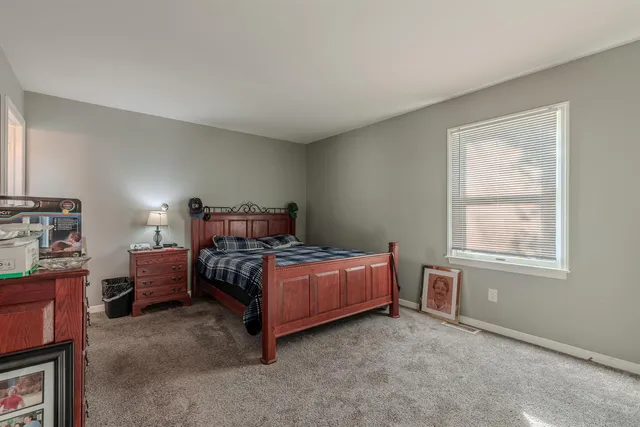 a bedroom with a bed and a dresser