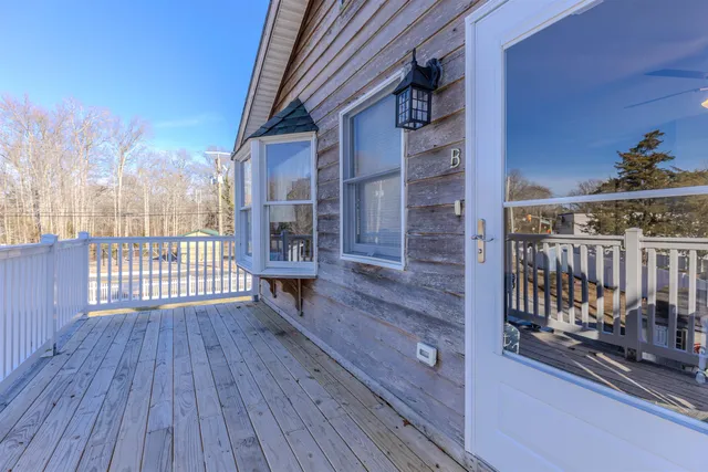 a view of a balcony with wooden floor and fence