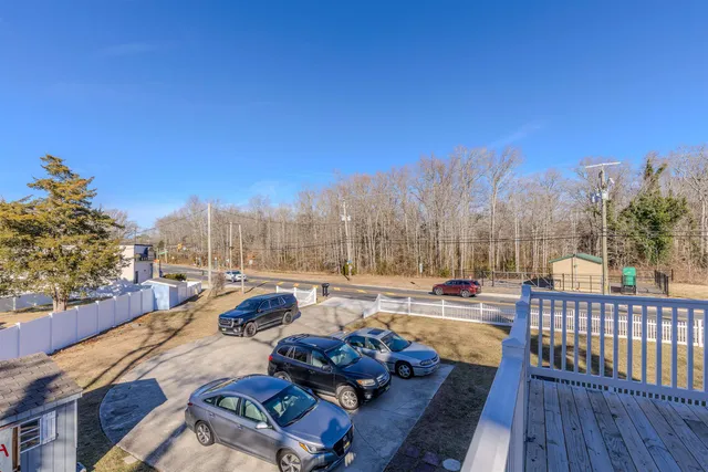 a view of balcony with wooden floor and fence