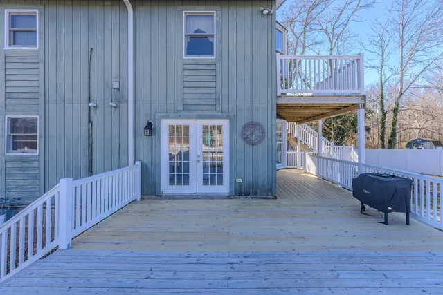 a view of a porch with furniture and wooden floor